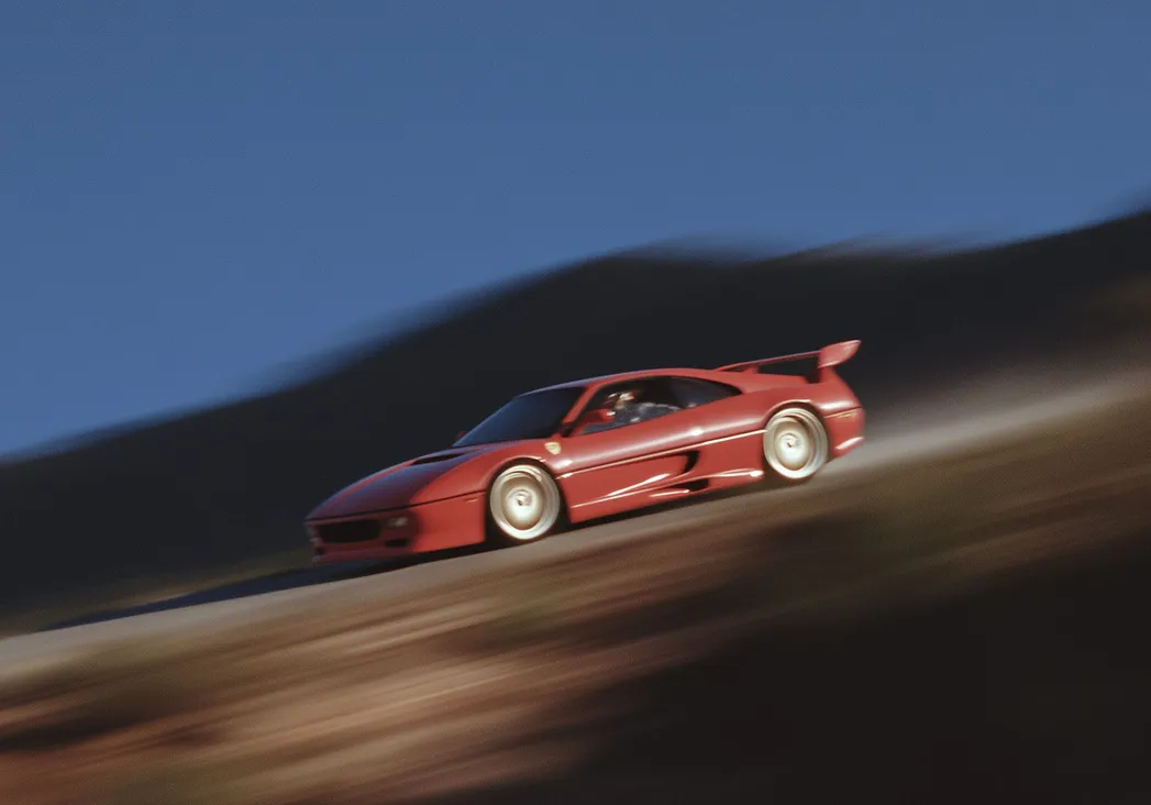 Red sports car driving fast along a mountain road at dusk